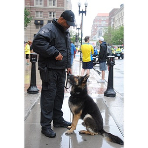 A Boston police officer looks down at his dog at One Run