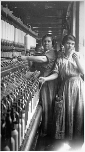 Two female textile workers at a spinning frame. [02]