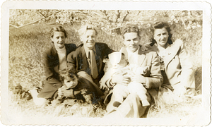 Manny Dias posing with family outside