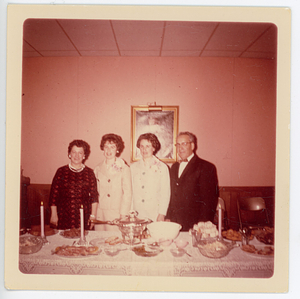 Group standing behind table