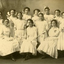 Twelve girls in white dresses