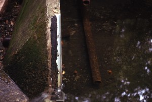 V-notch wier (on left) and wellhouse pipes (upper and middle center) in ponding basin of South Branch of Birch Brook stream gauging station.