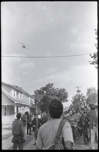 Antiwar demonstration at Fort Dix, N.J.: protesters looking up at helicopter