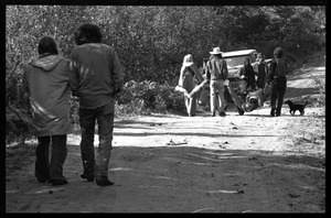 Hippie carrying their gear down a dirt road, Earth People's Park