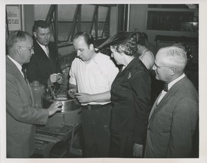 Mary Switzer and a group of men observe a trainee at the Institute for the Crippled and Disabled