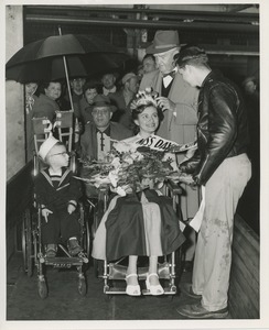 Young woman crowned and given flowers