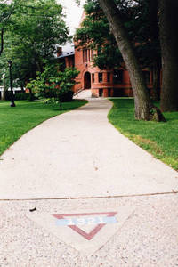 Springfield College seal in front of the Judd Gymnasia, ca. 2000