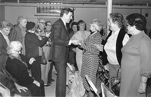 Mayor Raymond L. Flynn dancing with an unidentified woman while others look on