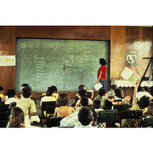 Teacher presenting a lesson to students at the chalkboard