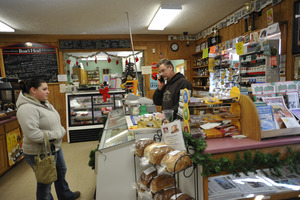 Rick Oliver talking on a cell phone while staffing the counter at the New Salem General Store