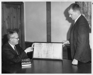 John W. Lederle looking at framed copy of the Commonwealth of Massachusetts Constitution