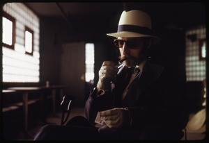 Leon Redbone lighting a cigar at Joe's Place
