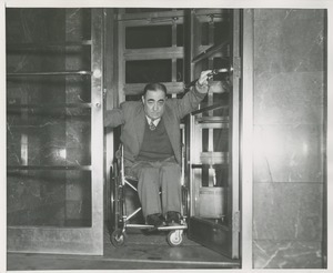 Man in a wheelchair exiting a building