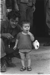 American war baby in Tay Ninh with wounded American soldier.