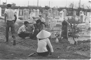 Vietnamese women at burial of Vietnamese officer killed during fighting in Saigon.