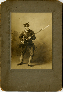 John Dutra Rose, posing with gun