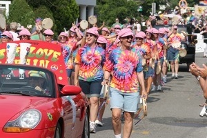 Paraders in tie-dyed shirts and pink hats : Provincetown Carnival parade