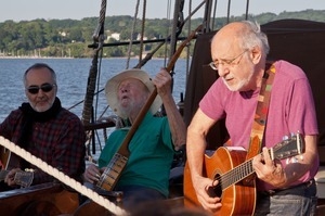 Pete Seeger (center) performing on the Mystic Whaler with Raffi (left) and Peter Yarrow during the Clearwater Festival