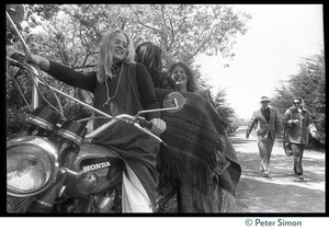 Drapeti, Cathy Brown (Usha), and Leenda seated on a motorcycle at Stinson Beach