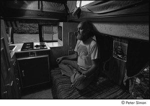 Ram Dass in his van: Ram Dass meditating next to a picture of Neem Karoli Baba