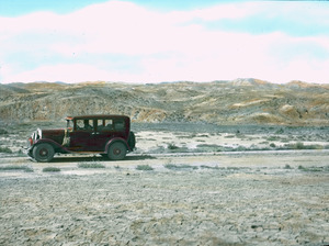 Old red automobile in the desert