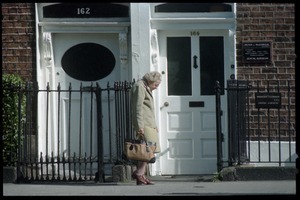 Older woman walking down a Pembroke Road, Dublin, across from the U.S. embassy