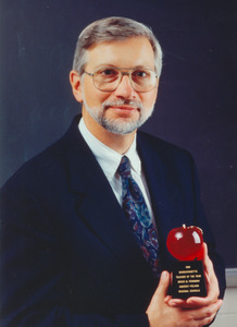 Bruce M. Penninman holding an award