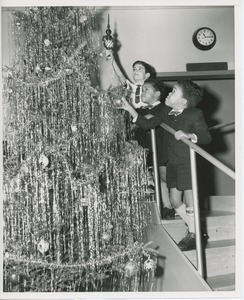 Young clients decorating Christmas tree