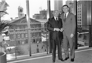 Mayor Raymond L. Flynn in his office posing with an unidentified man