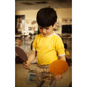 Boy holding a paddle