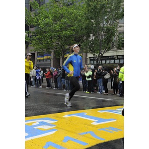 Runner crossing finish line at "One Run" event in Boston (May 2013)