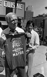 Mayor Kevin White holding a t-shirt at the 1979 August Moon Festival