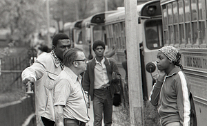 Individuals with school busses during student busing in Hyde Park