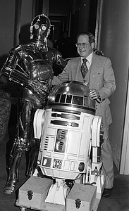 Unidentified man with C-3P0 and R2-D2 from Star Wars films at Boston City Hall