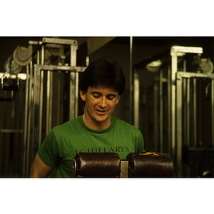 Man standing at an exercise machine in a gym