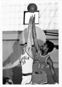 Suffolk University men's basketball player Chris Tsiotos (#33) goes up for a jump ball in a game versus Merrimack, circa 1978-1979