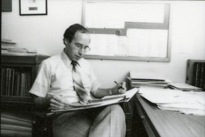 Suffolk University Professor and Associate Dean Marc G. Perlin (Law) seated at desk reviewing papers