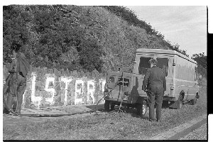 Graffiti removal, Downpatrick, workers from "Dynorod" remove political graffiti, "Ulster says NO," from a wall in Downpatrick