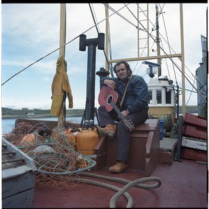 John Watt, "Ireland's singing farmer," portraits and sitting on fishing boat in Ardglass