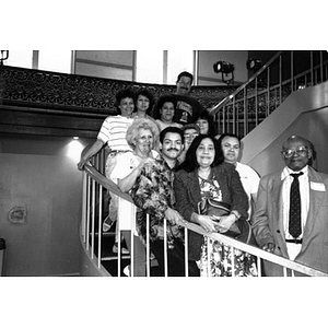 Group portrait of Inquilinos Boricuas en Acción board members standing on the spiral staircase at the Jorge Hernandez Cultural Center.