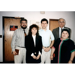 Inquilinos Boricuas en Acción staff members posing for a picture with an unidentified man in a suit.