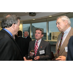 Richard Neal and John Pignato listen to a man speak at the Veterans Memorial dinner