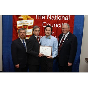 Victor Tong poses with his certificate and three others at the National Council Dinner