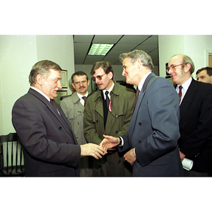 Lech Walesa and President Curry shake hands at the inauguration of the International Degree Program