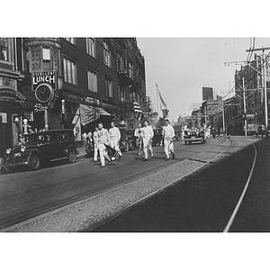 Male cheerleaders lead parade on Huntington Avenue for the arrival of mascot King Husky I