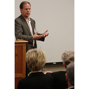 Peter Barrett, PhD '79, addresses the audience at the NU Today Cancer Research Panel