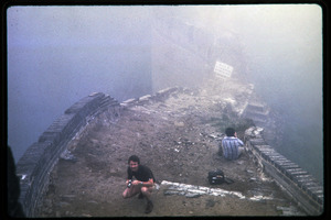 Men standing on top the mist-shrouded Great Wall