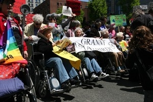 Granny Jailbirds with the banner, several in wheelchairs, during the protest against the war in Iraq