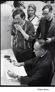 Malcolm Boyd at Boston University: Boyd (seated) in the BU News room with (l-r) Raymond Mungo, Joe Pilati, an unidentified woman, and an unidentified man