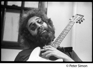 Jerry Garcia: portrait with guitar and cigarette